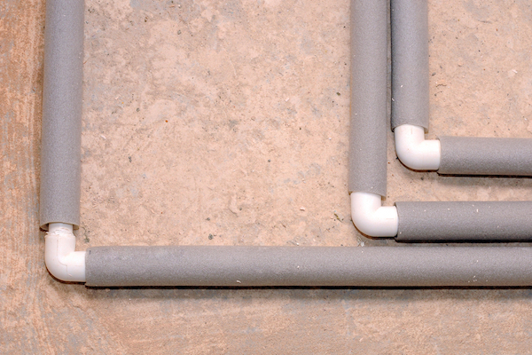 Pipes wrapped in grey insulation