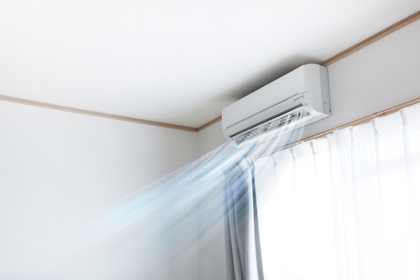Wall air conditioner unit blowing cool air into home
