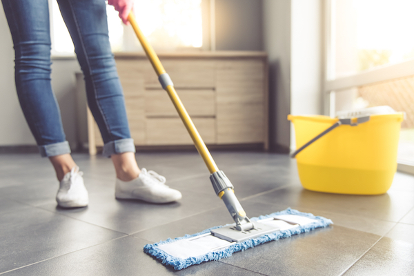 Homeowner mopping linoleum floor