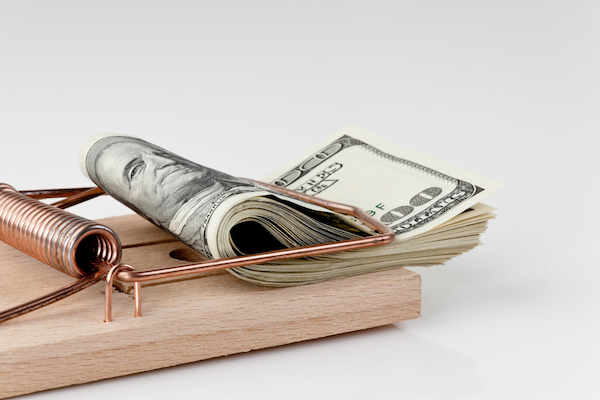 Mouse trap affixed with a wad of cash